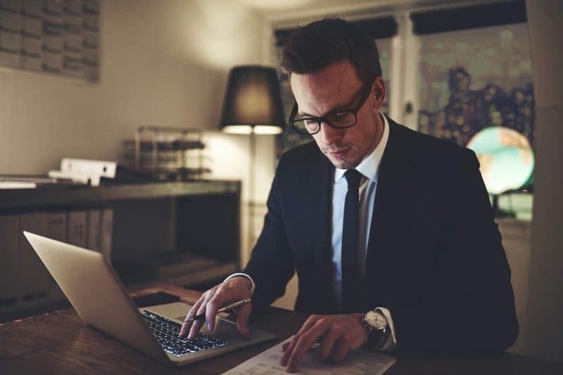 Business man working on documents - Cozie homes